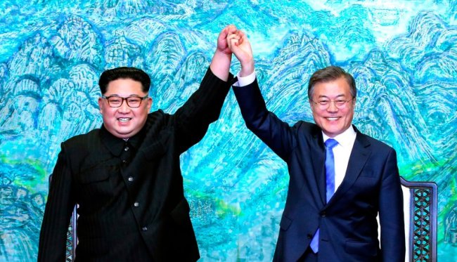 North Korean leader Kim Jong Un, left, and South Korean President Moon Jae-in raise their hands after signing a joint statement at the border village of Panmunjom in the Demilitarized Zone, South Korea on April 27. (AP)