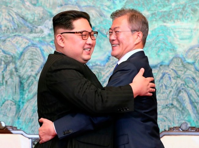 North Korean leader Kim Jong Un, left, and South Korean President Moon Jae-in embrace each other after signing on a joint statement at the border village of Panmunjom in the Demilitarized Zone, South Korea on April 27. (AP)