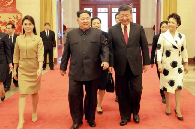 North Korean leader Kim Jong Un and wife Ri Sol-ju, and Chinese President Xi Jinping and wife Peng Liyuan walk together in Beijing, China. (Reuters)