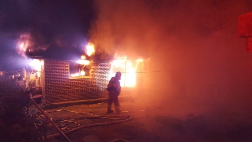 A fire sets a house ablaze in Jeongeup, North Jeolla Province, on Thursday. (Yonhap)