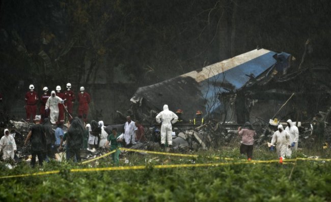Rescue teams search through the wreckage site of a Boeing 737 that plummeted into a cassava field with more than 100 passengers on board, in Havana, Cuba, Friday, May 18. (AP)