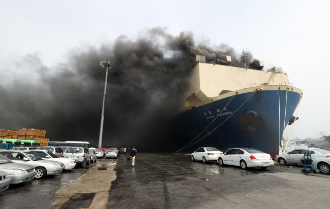 A big fire takes place on a Panama-registered car carrier at the port of Incheon on May 21, 2018. (Yonhap)
