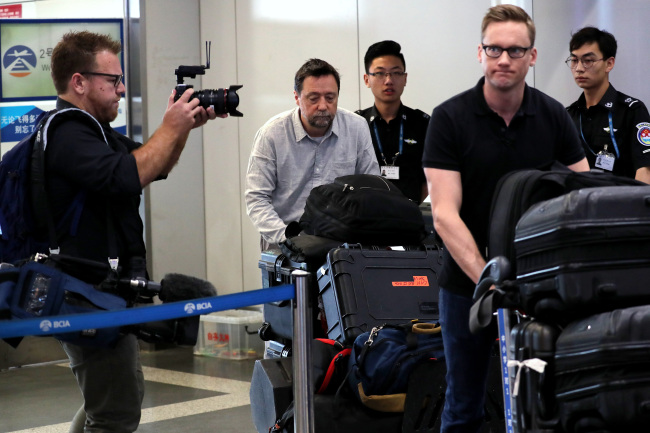 Will Ripley (front, right) from CNN and other foreign journalists head to catch a flight to Wonsan, North Korea, at Beijing Capital Airport on Tuesday. (Pool-Yonhap)