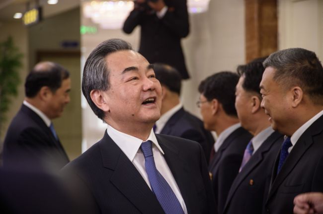 Chinese Foreign Minister Wang Yi greets North Korean officials in Pyongyang on May 2. (Yonhap)