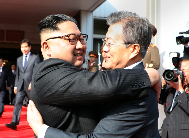 SOuth Korea's President Moon Jae-in hugs with North Korea's leader Kim Jong-un. Yonhap