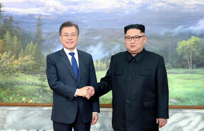 South Korea President Moon Jae-in shakes hands with North Korean leader Kim Jong-un at their summit meeting held at the northern side of Panmunjeom on Saturday. (Cheong Wa Dae-Yonhap)