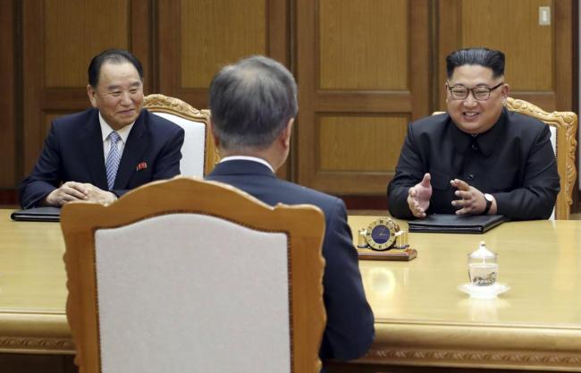 North Korean leader Kim Jong Un, right, talks with South Korean President Moon Jae-in, center, during a meeting at the northern side of Panmunjom in North Korea. (AP)