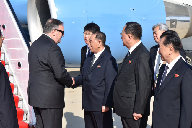 US Secretary of State Mike Pompeo (left) is greeted by senior North Korean official Kim Yong-chol, director of the United Front Department, which is responsible for North-South Korea affairs, on his arrival in Pyongyang, North Korea, on May 9, 2018. (AP-Yonhap)