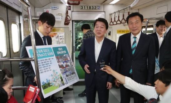This photo, taken on May 28, 2018, shows Ahn Cheol-soo (C), the Seoul mayoral candidate of the minor opposition Bareunmirae Party, campaigning on a subway train ahead of the June 13 local elections. (Yonhap)