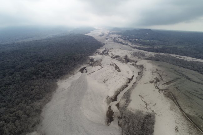 This aerial view shows the disaster zone near the Volcan de Fuego, or "Volcano of Fire," in Escuintla, Guatemala. The fiery volcanic eruption in south-central Guatemala killed scores as rescuers struggled to reach people where homes and roads were charred and blanketed with ash. (AP-Yonhap)