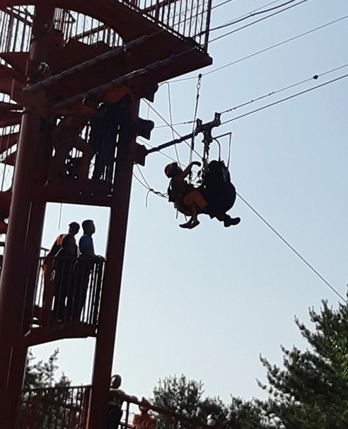 Emergency services respond to a 9-year-old stuck on a zip line. (Yonhap)
