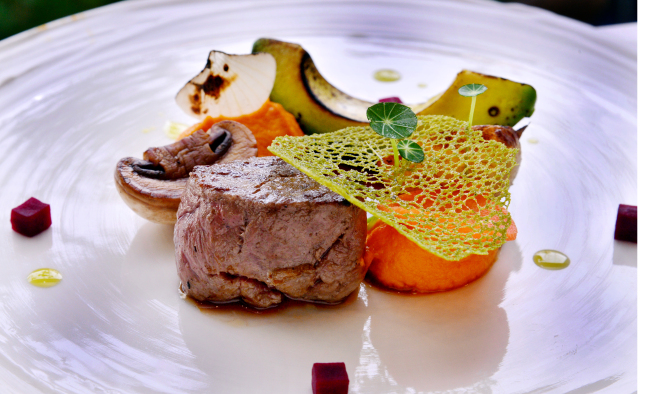 Hulotte's strip loin pairs juicy cuts of beef coated in a caramelized glaze of cumin, honey and balsamic vinegar with vegetables including grilled avocado, carrot puree and pickled beets. (Photo credit: Park Hyun-koo/The Korea Herald)