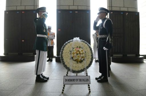 South Korean honour guards salute at the Korean War Memorial in Seoul. Tuesday's unprecedented US-North Korea summit could finally pave the way for the longest ceasefire in history to be replaced by a peace treaty. (AFP-Yonhap)