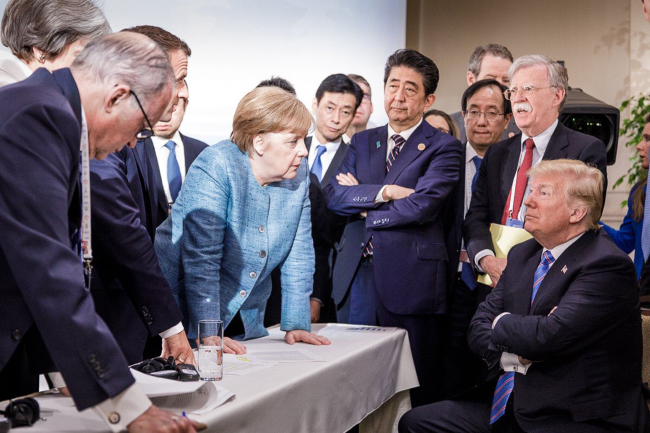 German Chancellor Angela Merkel speaks to US President Donald Trump during sideline discussions on Day 2 of the G7 Summit in La Malbaie, Quebec, Canada, on June 9, 2018. (UPI-Yonhap)