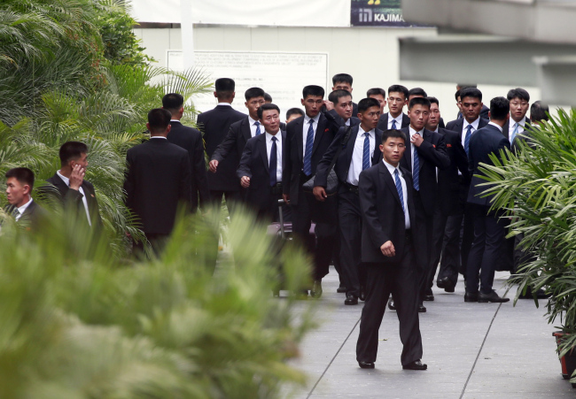 North Korean security personnel arrive at the St Regis hotel, where North Korean leader Kim Jong-un will stay, ahead of his expected arrival, in Singapore, 10 June 2018. (EPA-Yonhap)