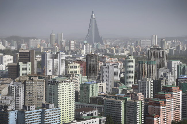 The 105-story pyramid-shaped Ryugyong Hotel towers over residential apartments, forming the skyline of Pyongyang, North Korea. (AP)