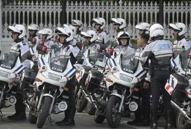 Police officers escorting the motorcade of North Korea leader Kim Jong-un park after he arrives at the Istana, or Presidential Palace, in Singapore. (AP-Yonhap)