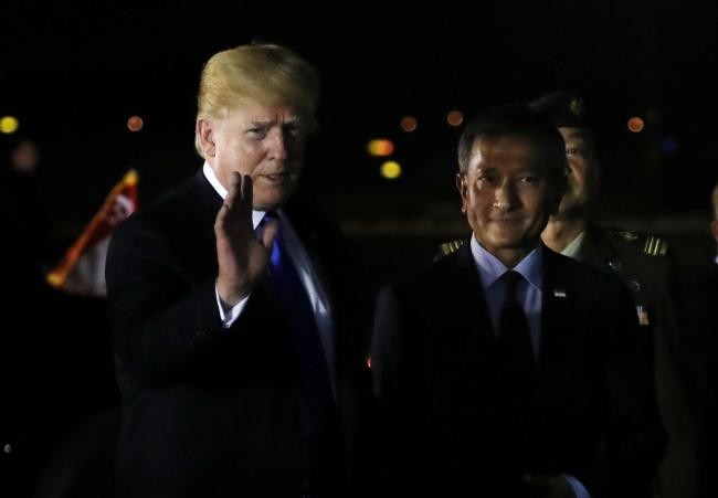 US President Donald Trump waves next to Singapore's Foreign Minister Vivian Balakrishnan after arriving in Singapore on June 10. (Reuters)