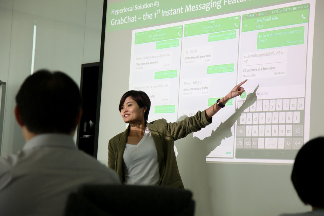 Grab co-founder and COO Hooi Ling Tan introduces Grab in a presentation at Grab’s headquarters in Singapore on June 8 (Grab)