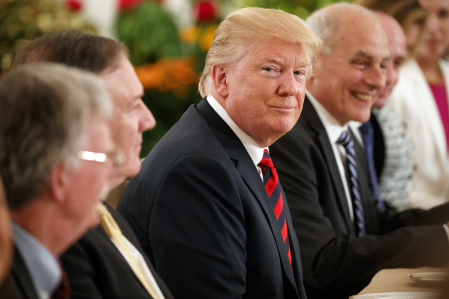 President Donald Trump listens during a meeting with Singapore Prime Minister Lee Hsien Loong ahead of a summit with North Korean leader Kim Jong-un, Monday, in Singapore. (AP-Yonhap)