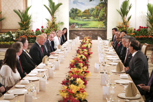 US President Donald J. Trump (4-L) and Singapore Prime Minister Lee Hsien Loong (4-R) meet for a working lunch at The Istana (presidential residence) in Singapore on Monday. (EPA-Yonhap)