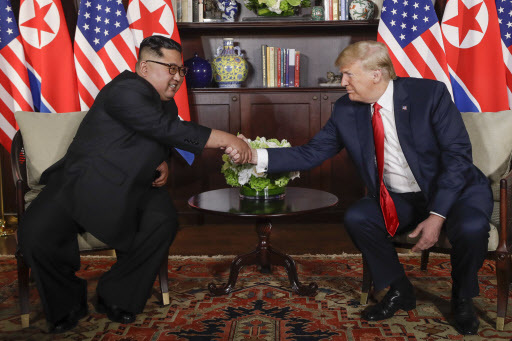 US President Donald Trump shakes hands with North Korea leader Kim Jong-un during their first meetings at the Capella resort on Sentosa Island Tuesday, June 12, 2018 in Singapore. (AP)