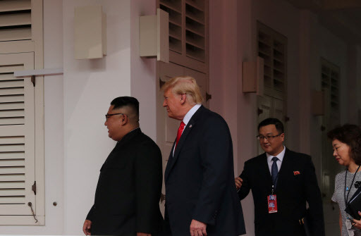 US President Donald Trump walks with North Korean leader Kim Jong-un at the Capella Hotel on Sentosa island in Singapore June 12, 2018. (Reuters)