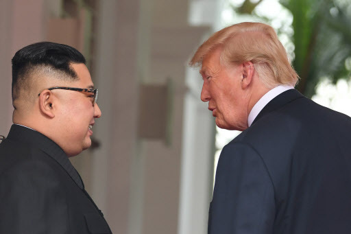 North Korea's leader Kim Jong-un (L) and US President Donald Trump meet at the start of their historic US-North Korea summit, at the Capella Hotel on Sentosa island in Singapore on June 12, 2018. Donald Trump and Kim Jong-un have become on June 12 the first sitting US and North Korean leaders to meet, shake hands and negotiate to end a decades-old nuclear stand-off. (AFP)