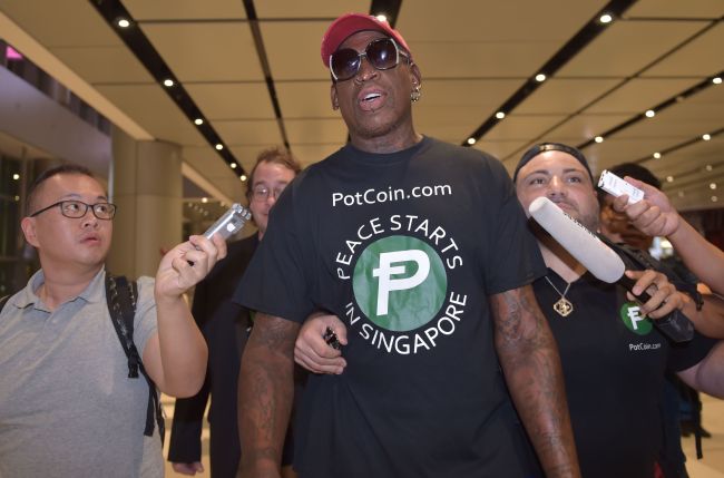 Retired American professional basketball player Dennis Rodman speaks to the press as he arrives at Changi International airport ahead of US-North Korea summit in Singapore on June 11, 2018.(AFP)
