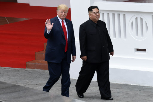 US President Donald Trump and North Korea leader Kim Jong-un walk from lunch at the Capella resort on Sentosa Island Tuesday in Singapore. (AP)