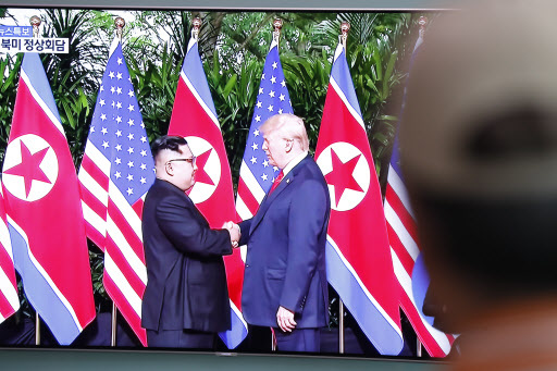 South Korean watches a TV screen displaying a broadcast of the historic meeting between US President Donald J. Trump and North Korean leader Kim Jong-un in Singapore, at a station in Seoul, South Korea, 12 June 2018. The summit marks the first meeting between an incumbent US President and a North Korean leader. / EPA