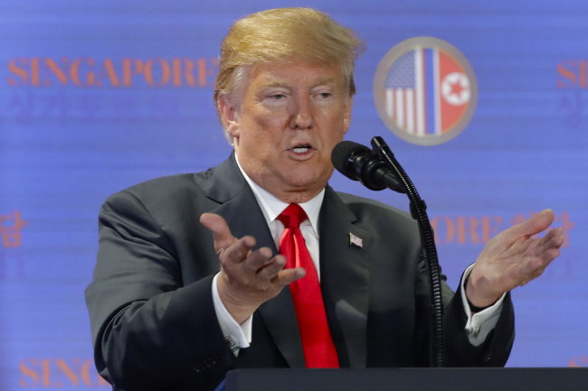 US President Donald Trump answers questions about the summit with North Korea leader Kim Jong-un during a press conference at the Capella resort on Sentosa Island, Tuesday, in Singapore. (AP-Yonhap)