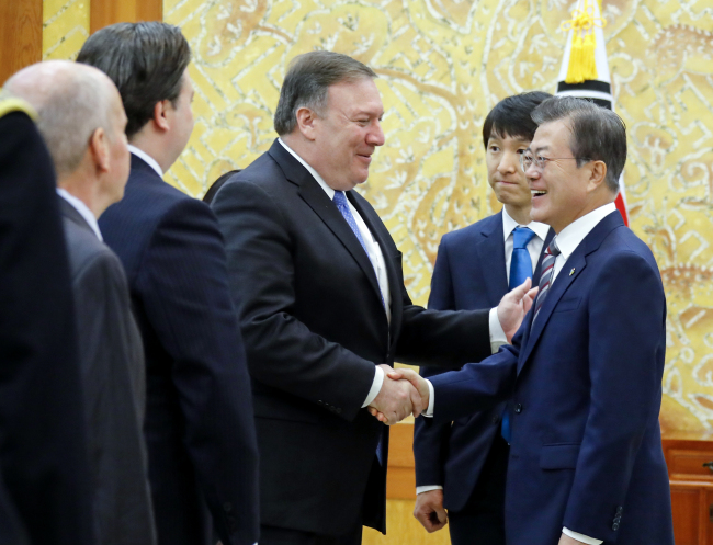 South Korean President Moon Jae-in, right, shakes hands with US Secretary of State Mike Pompeo at the Blue House in Seoul on Thursday. (Yonhap)
