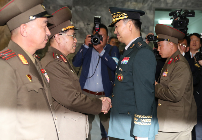 South Korea's Major General Kim Do-gyun (second from right) shakes hands with North Korea's Lieutenant General An Ik-san (second from left) at the northern side of Panmunjeom in Paju, Gyeonggi Province, Thursday. (Yonhap)