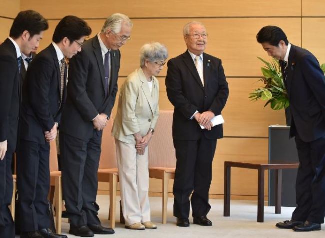 Japan's Prime Minister Shinzo Abe (R) meets family members of victims abducted to North Korea at the Prime Minister's official residence in Tokyo, Japan, on Thursday. (Reuters)