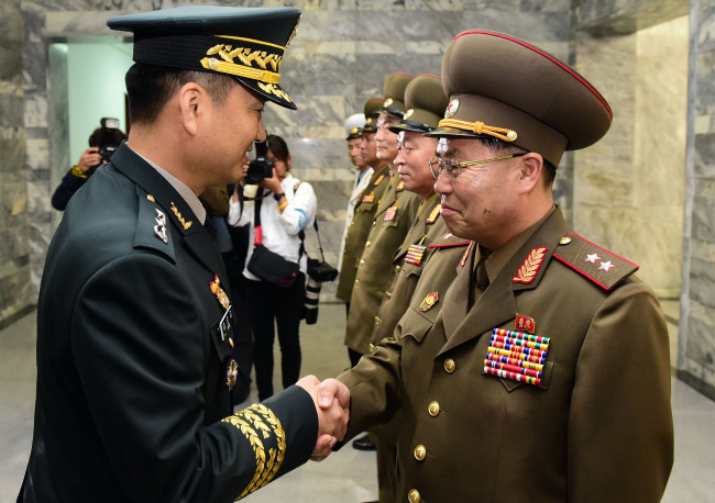 Military officials from the two Koreas hold rare talks at the inter-Korean truce village of Panmunjeom on Thursday, in this photo released by the joint press corps. (Yonhap)