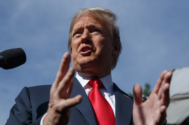 President Donald Trump speaks to reporters at the White House, in Washington on Friday, June 15. (AP-Yonhap)