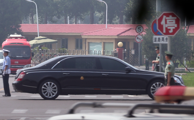 A vehicle, speculated to be that of North Korean high-level officials, departs from Beijing Capital International Airport on Tuesday. (Yonhap)