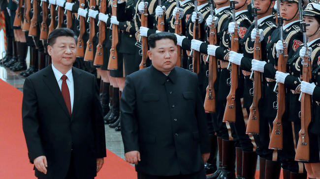 In a file photo taken on March 28, North Korean leader Kim Jong-un and Chinese President Xi Jinping inspect guards of honor in Beijing. (Reuters)