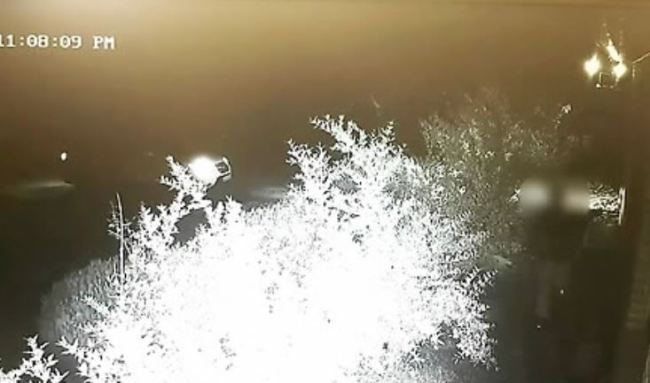 A man is seen leaving his house through the backdoor Saturday night. (Yonhap)