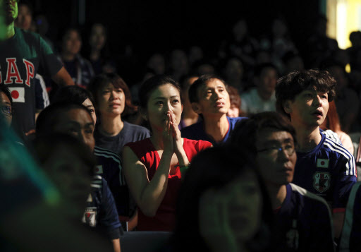 Japanese soccer fans react as they watch Japan receive the third goal from Belgium during the FIFA World Cup 2018 round of 16 soccer match between Japan and Belgium at a public viewing venue in Tokyo, Japan, in the early morning 03 July 2018. EPA