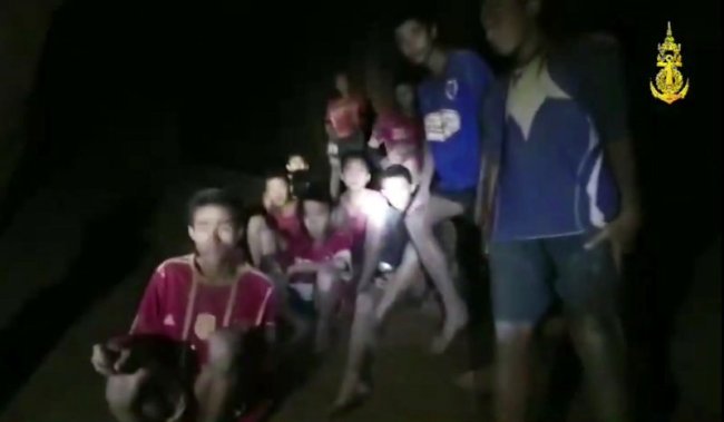 In this grab taken from video provided by the Thai Navy Seal, a view of the boys and their soccer coach as they are rescued in a cave, in Chiang Rai in Thailand, Monday, July 2, 2018. Rescuers found all 12 boys and their soccer coach alive deep inside a partially flooded cave in northern Thailand late Monday, more than a week after they disappeared and touched off a desperate search that drew international help and captivated the nation. (Thai Navy Seal via AP)
