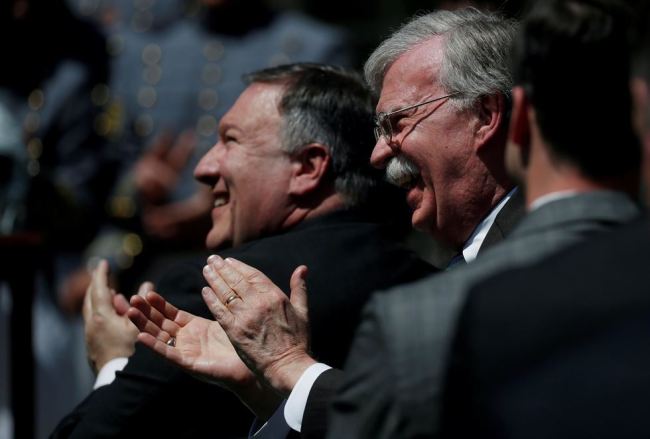 US Secretary of State Mike Pompeo, left, and National Security Advisor John Bolton applaud as President Donald Trump presents the Commander-in-Chief's Trophy to the US Military Academy football team in the Rose Garden at the White House in Washington, May 1. (Reuters-Yonhap)