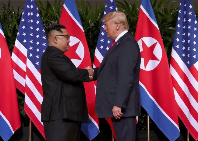 US President Donald Trump shakes hands with North Korean leader Kim Jong Un at the Capella Hotel on Sentosa island in Singapore June 12. (Reuters)