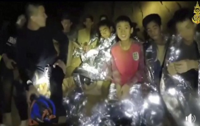 In this July 3 file image taken from video provided by the Thai Navy Seal, Thai boys are with Navy SEALs inside a cave in Mae Sai, northern Thailand. (AP)