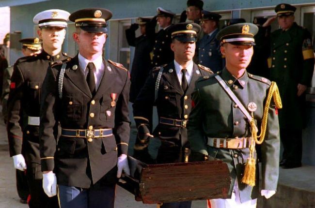 United Nations honor guards in December 1993 carry the remains of a soldier who died during the Korean War. (AFP)