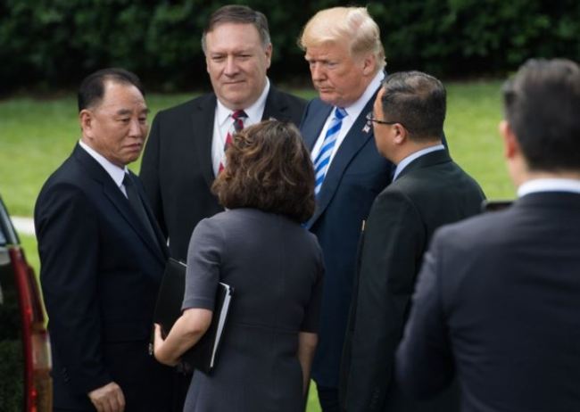 In a file photo taken on June 1, US President Donald Trump speaks with North Korean Kim Yong-chol (L) on the South Lawn of the White House in Washington, DC, after a meeting, as US Secretary of State Mike Pompeo (C) looks on. (AFP)