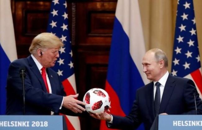 US President Donald Trump receives a football from Russian President Vladimir Putin as they hold a joint news conference after their meeting in Helsinki, Finland July 16. (Reuters)