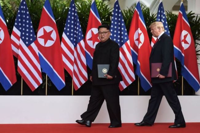 US President Donald Trump (right) walks out with North Korea's leader Kim Jong Un after taking part in a signing ceremony at the end of their historic US-North Korea summit, at the Capella Hotel on Sentosa island in Singapore.(AFP)
