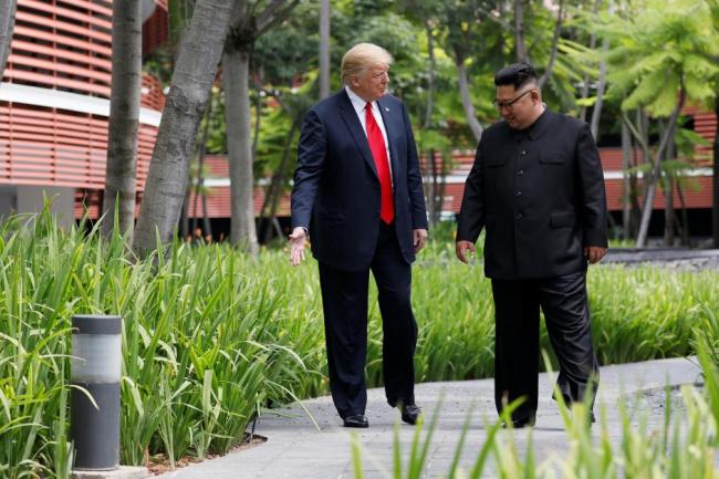 US President Donald Trump and North Korean leader Kim Jong-un walk after lunch at the Capella Hotel on Sentosa island in Singapore June 12. (Reuters)